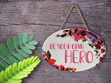 "Be Your Own Hero” | Oval Ceramic Wall Sign | 8 3/4" x 6” x 5/16”