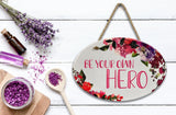 "Be Your Own Hero” | Oval Ceramic Wall Sign | 8 3/4" x 6” x 5/16”