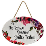 "Be the Reason Someone Smiles Today” | Oval Ceramic Wall Sign | 8 3/4" x 6” x 5/16”